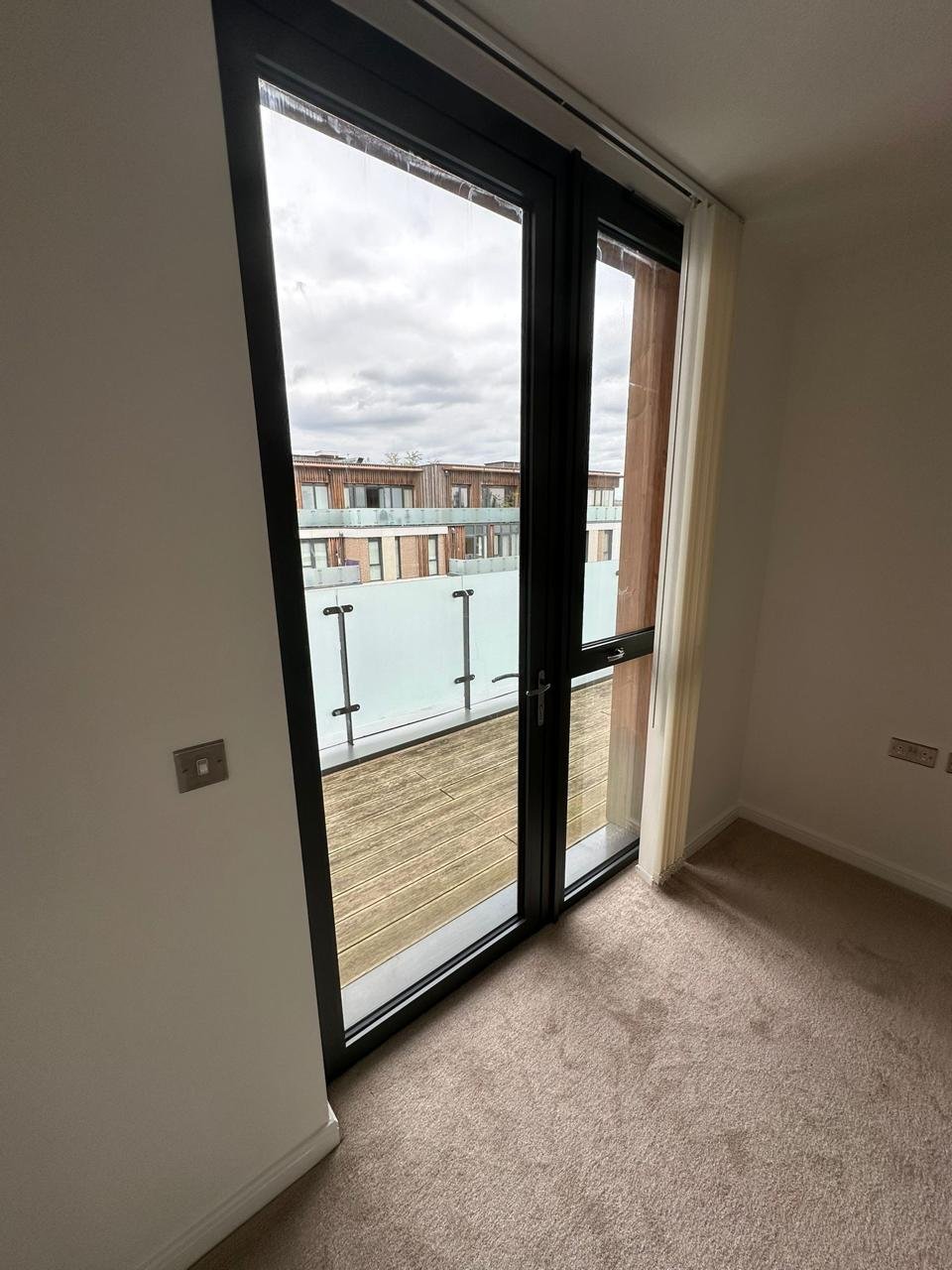 Clean balcony door, glass and carpet in an empty London flat
